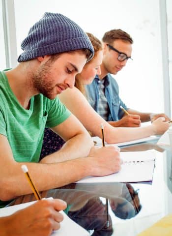 Students Writing on Notepad at the College